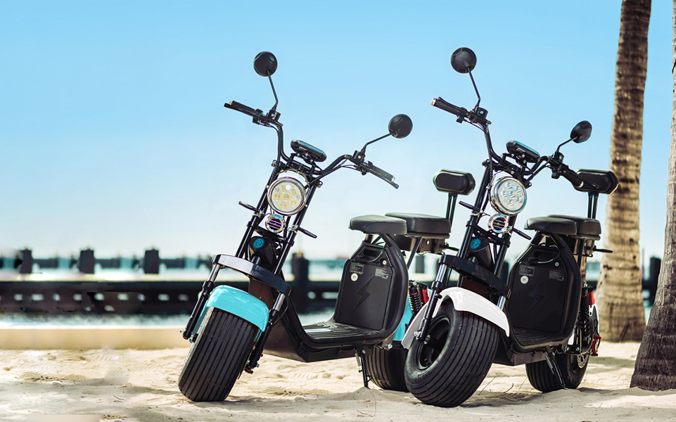 two cruzer scooters on a beach